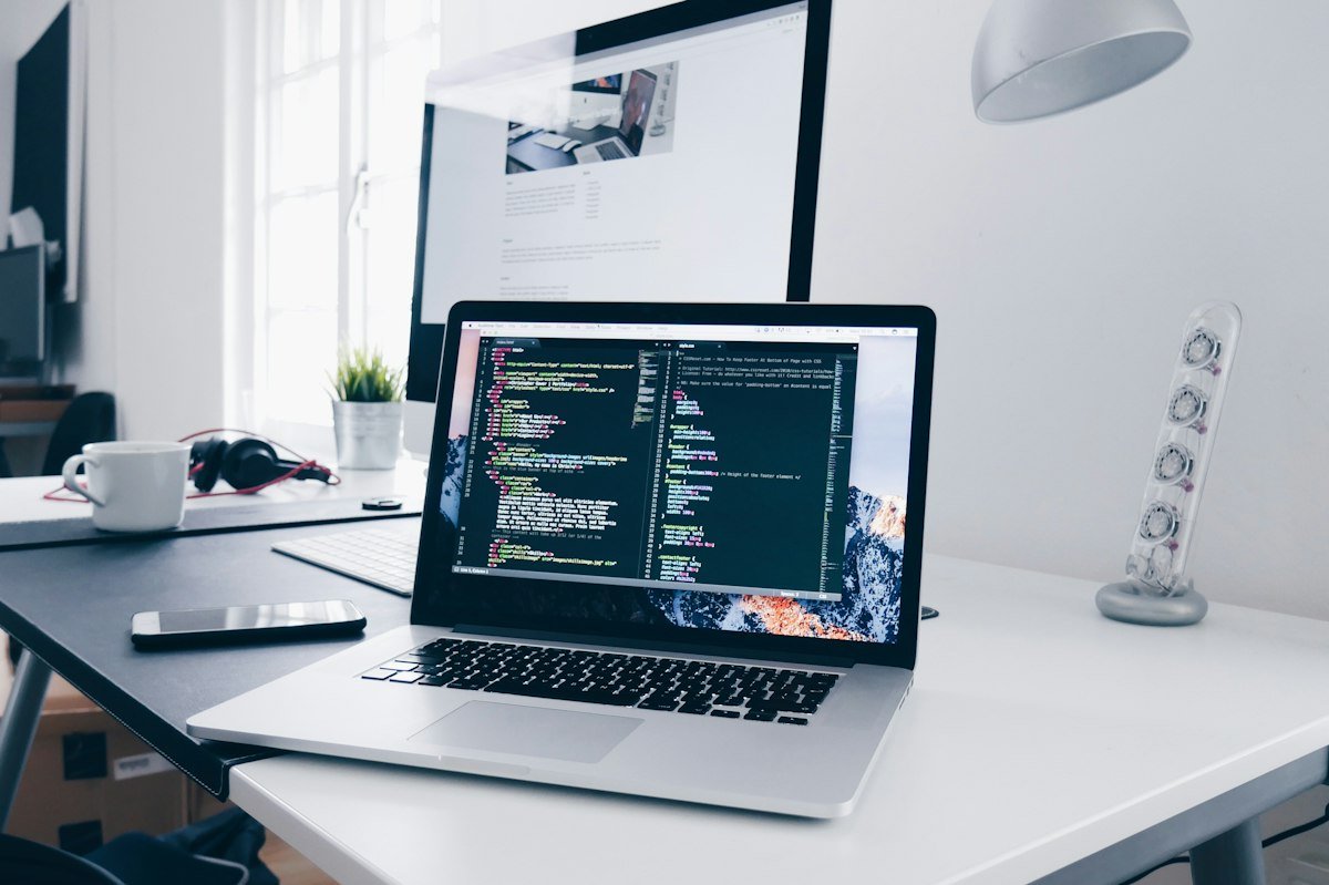 Laptop with a code editor on a workspace desk